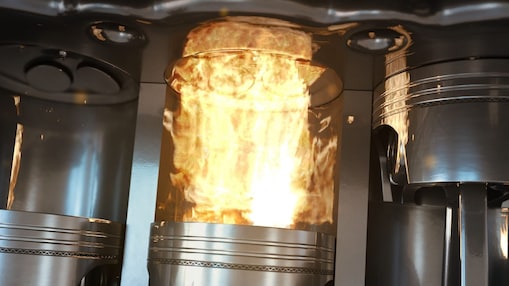 An up-close shot of car engine pistons firing