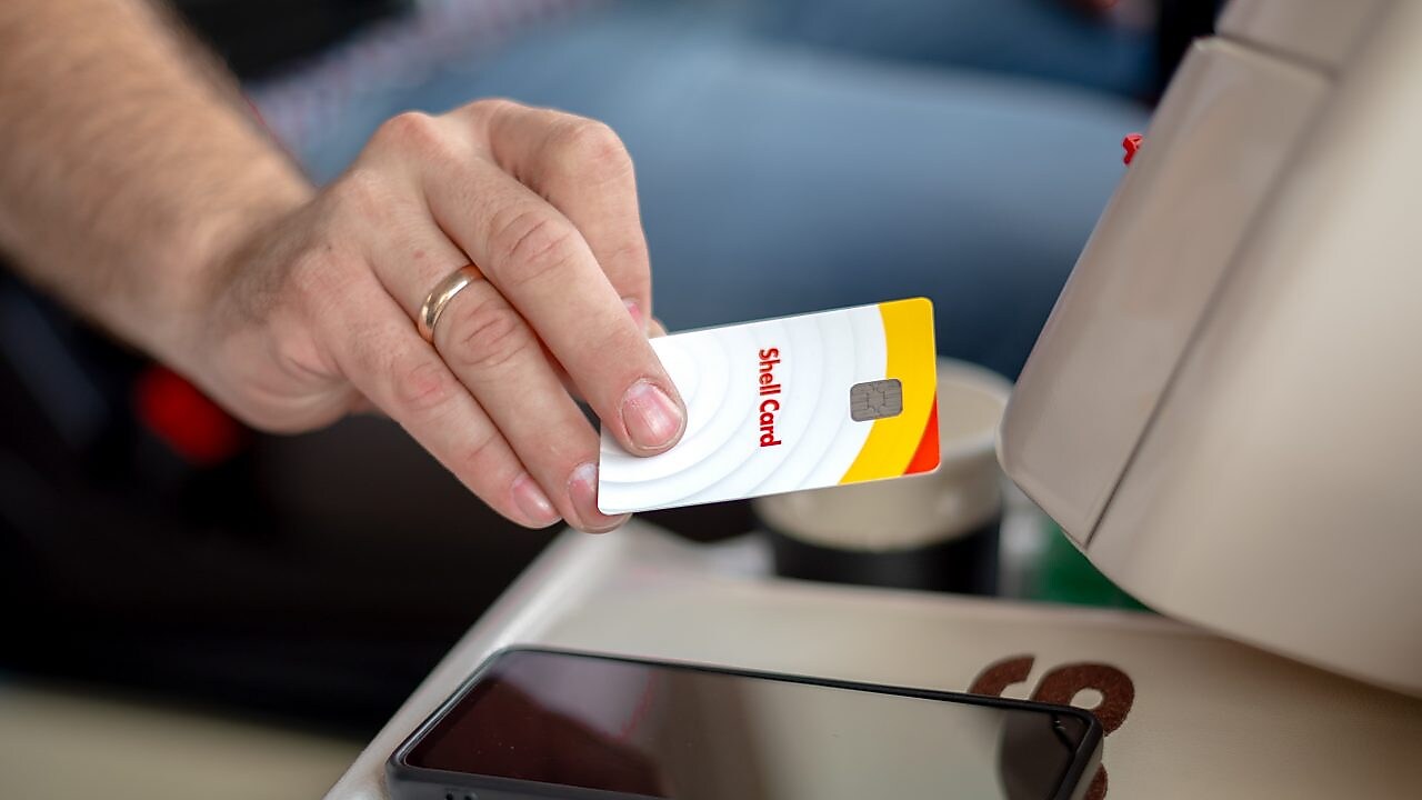 Truck driver holding a Shell card