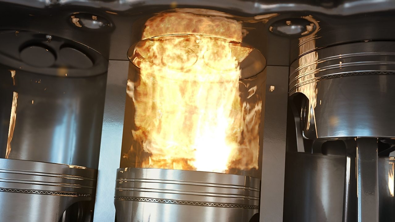 An up-close shot of car engine pistons firing