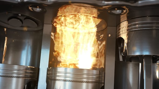 An up-close shot of car engine pistons firing